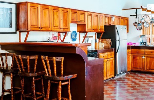 Granada House | You’ll know that you have rented a historic colonial home when you pass through huge, antique front doors framed by 3 foot-thick adobe walls. Lounge on the shallow, submerged bench seats in the pool or in the hammocks hanging between 12 foot wooden c