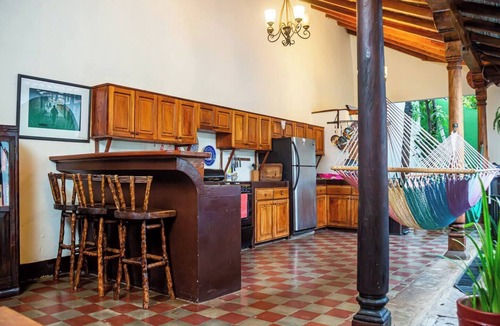 Granada House | You’ll know that you have rented a historic colonial home when you pass through huge, antique front doors framed by 3 foot-thick adobe walls. Lounge on the shallow, submerged bench seats in the pool or in the hammocks hanging between 12 foot wooden c